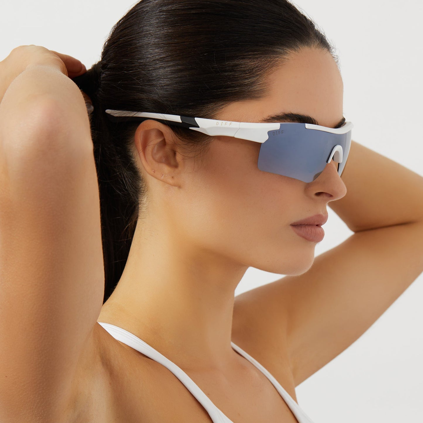 on model - female wearing diff sport blitz shield sunglasses with a matte white frame and grey gradient with silver flash polarized lenses side view