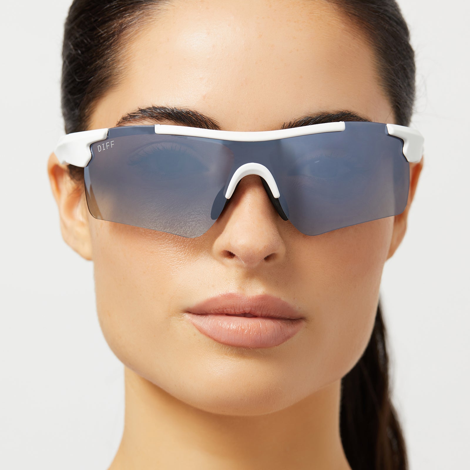 on model - female wearing diff sport blitz shield sunglasses with a matte white frame and grey gradient with silver flash polarized lenses front view