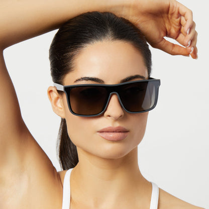 on model - female wearing diff sport flash square sunglasses with a slate grey frame and grey gradient with silver flash polarized lenses front view