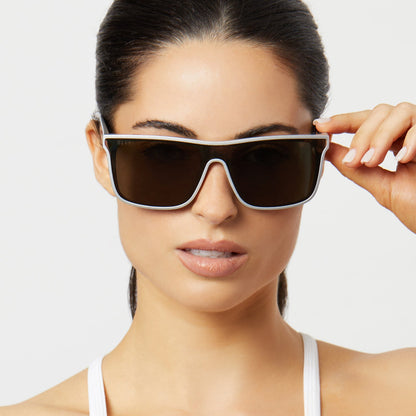 on model - female wearing diff sport flash square sunglasses with a silver frame and peach mirror polarized lenses front view