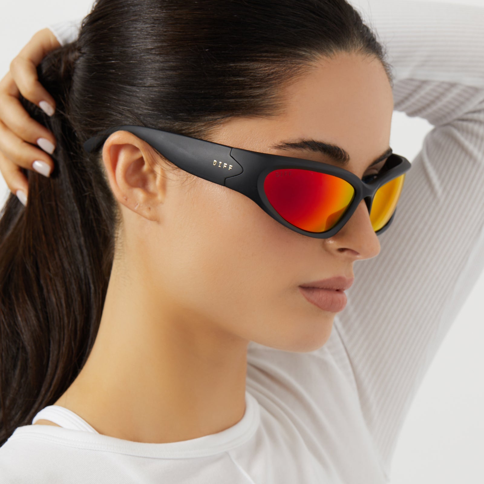 on model - female wearing diff sport side out wrap sunglasses with a matte black frame and sunset mirror polarized lenses side view