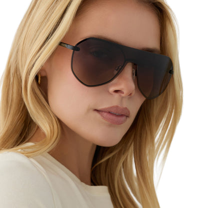 on model - blonde female wearing diff eyewear lonnie oversized aviator sunglasses with a black metal frame and twilight gradient polarized lenses angled view