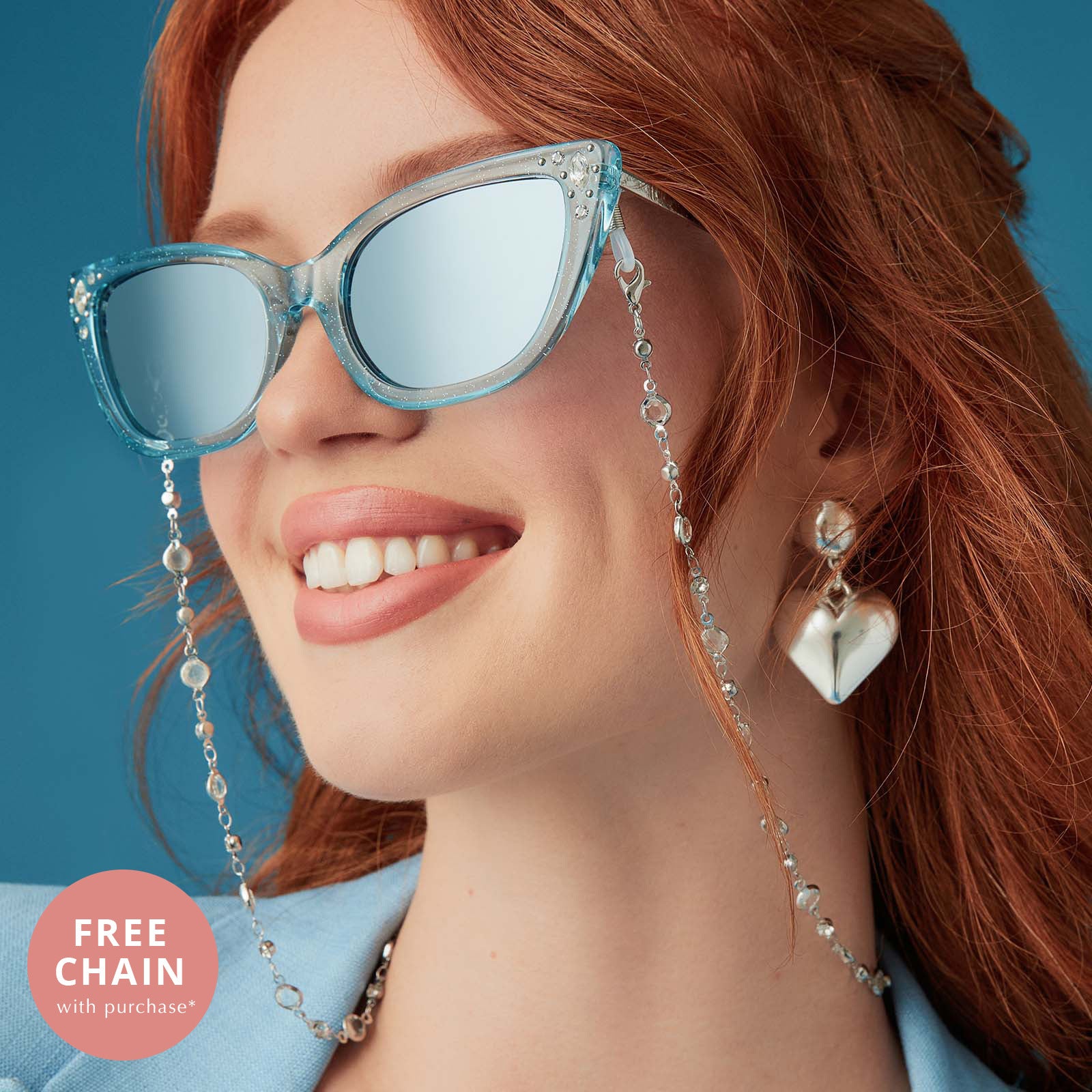 on model - female wearing disney princess x diff eyewear featuring the cinderella cateye sunglasses with a blue crystal glitter frame and blue dust gradient polarized lenses angled view and free chain with purchase