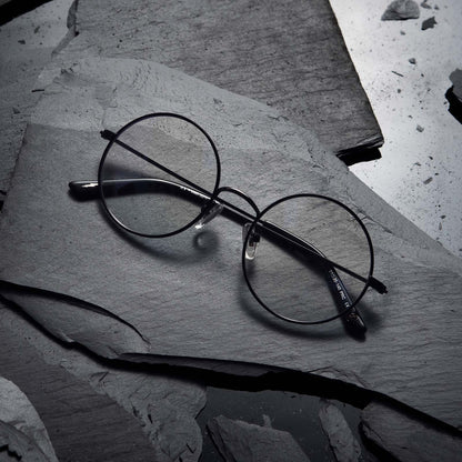 Flat-lay of Harry Potter x DIFF Harry Potter glasses lying folded on top of black broken stone