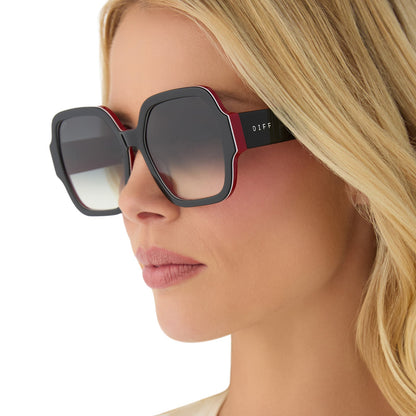 on model - female wearing clueless x diff eyewear featuring the dionne square sunglasses with a black frame and grey gradient lenses angled view