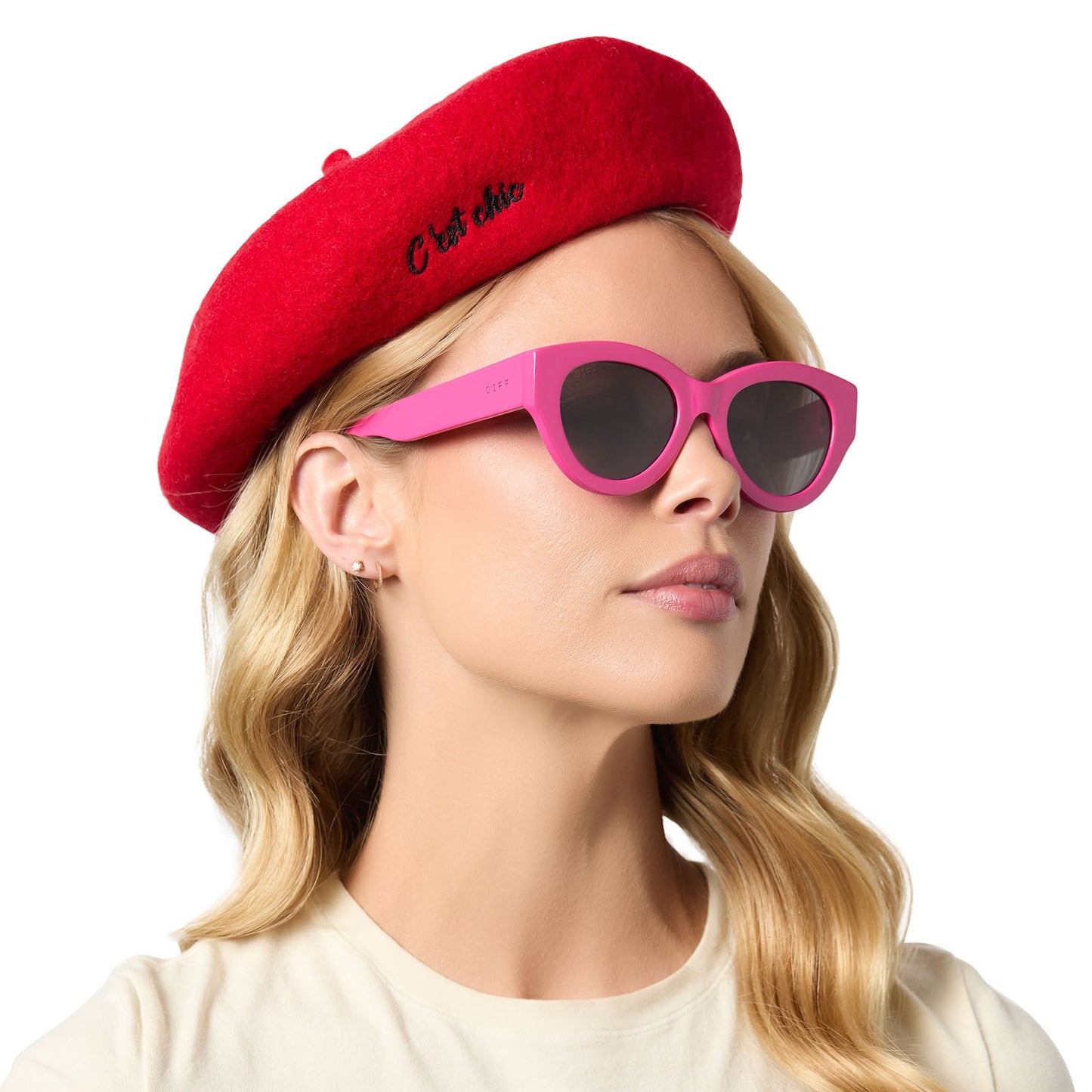 on model - female wearing diff eyewear x emily in paris featuring the emily pink cat eye sunglasses and free with purchase red beret hat side view