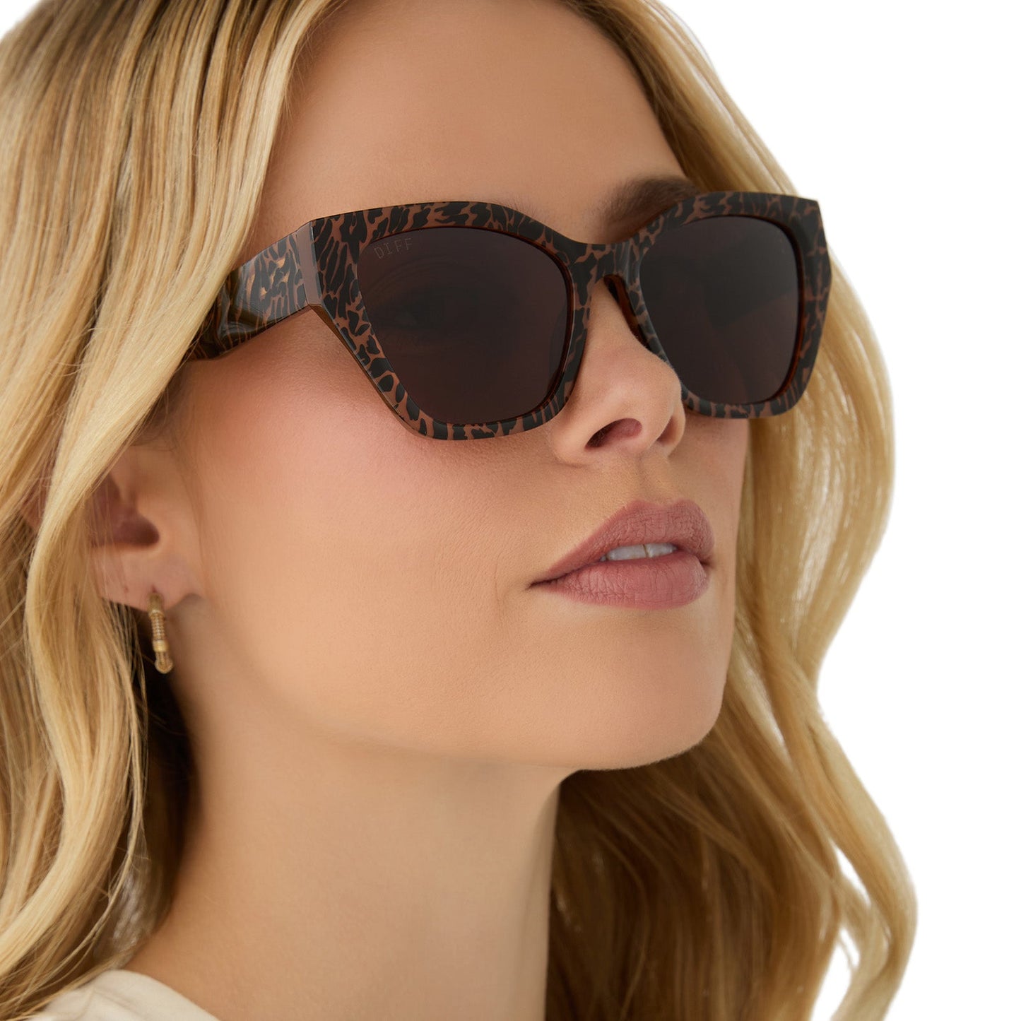 on model - female wearing diff eyewear featuring the evie cat eye sunglasses with a animal print frame and brown lenses angled view