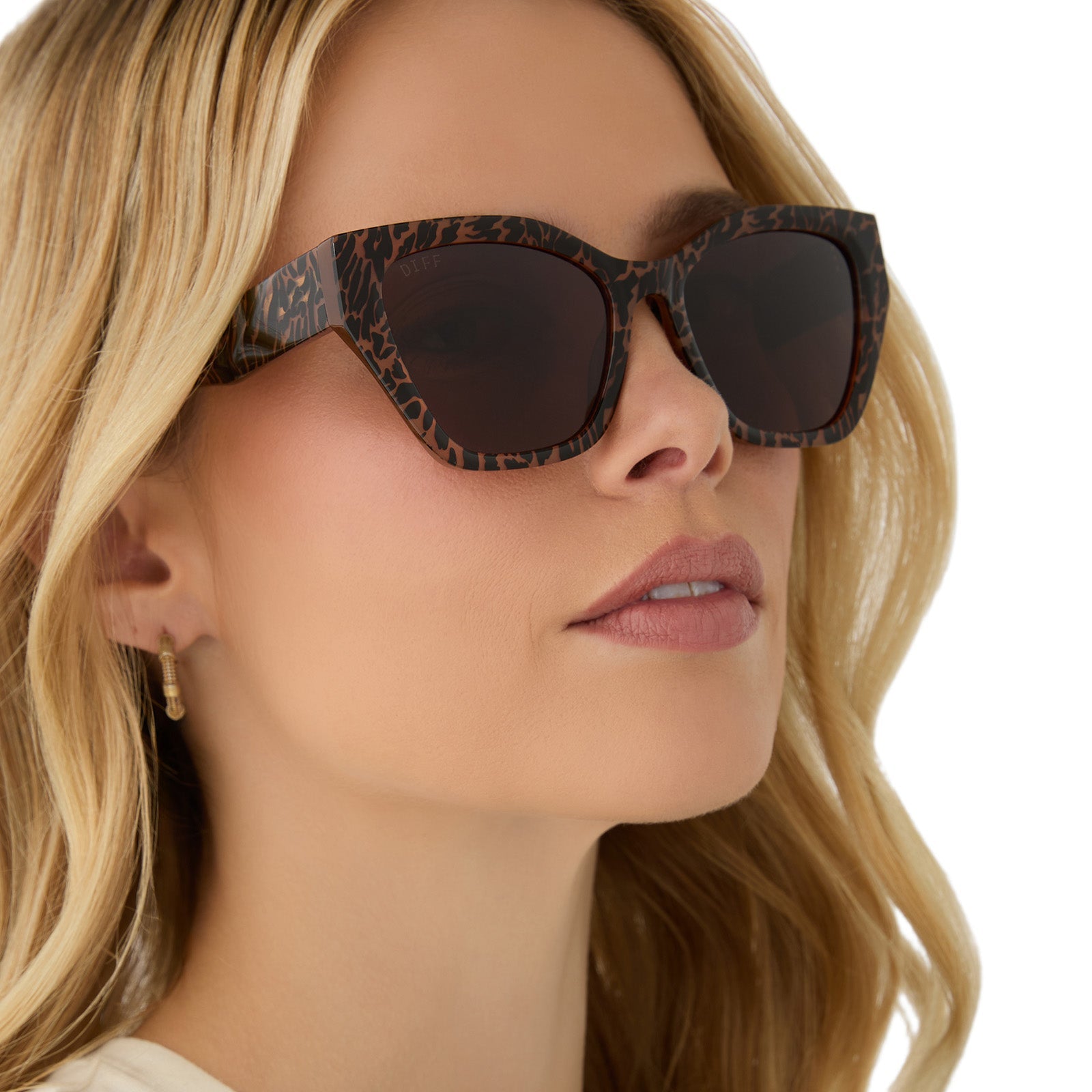 on model - female wearing diff eyewear featuring the evie cat eye sunglasses with a animal print frame and brown lenses angled view