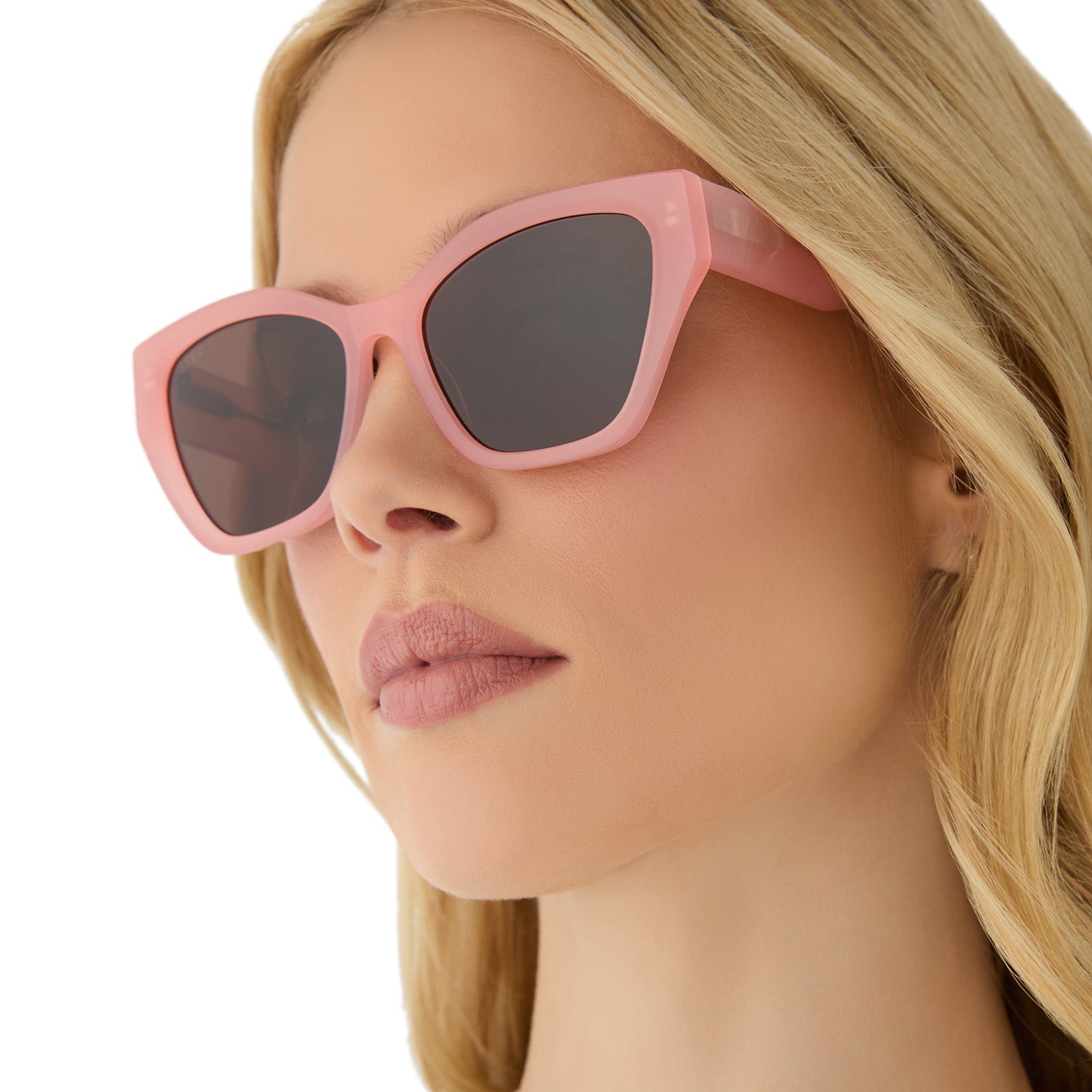on model - female wearing diff eyewear featuring the evie cat eye sunglasses with a peach frame and brown polarized lenses side view