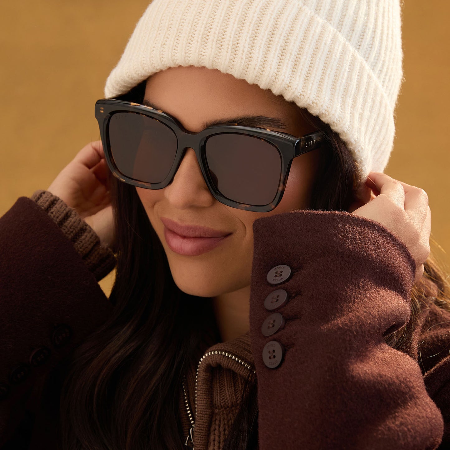lifestyle - female wearing diff eyewear meredith square sunglasses with a espresso tortoise acetate frame and brown polarized lenses front view