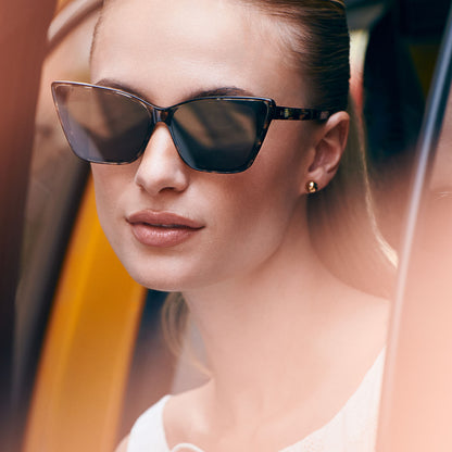on model - female wearing diff eyewear featuring the alina cat eye sunglasses with a espresso tortoise frame and grey lenses front view