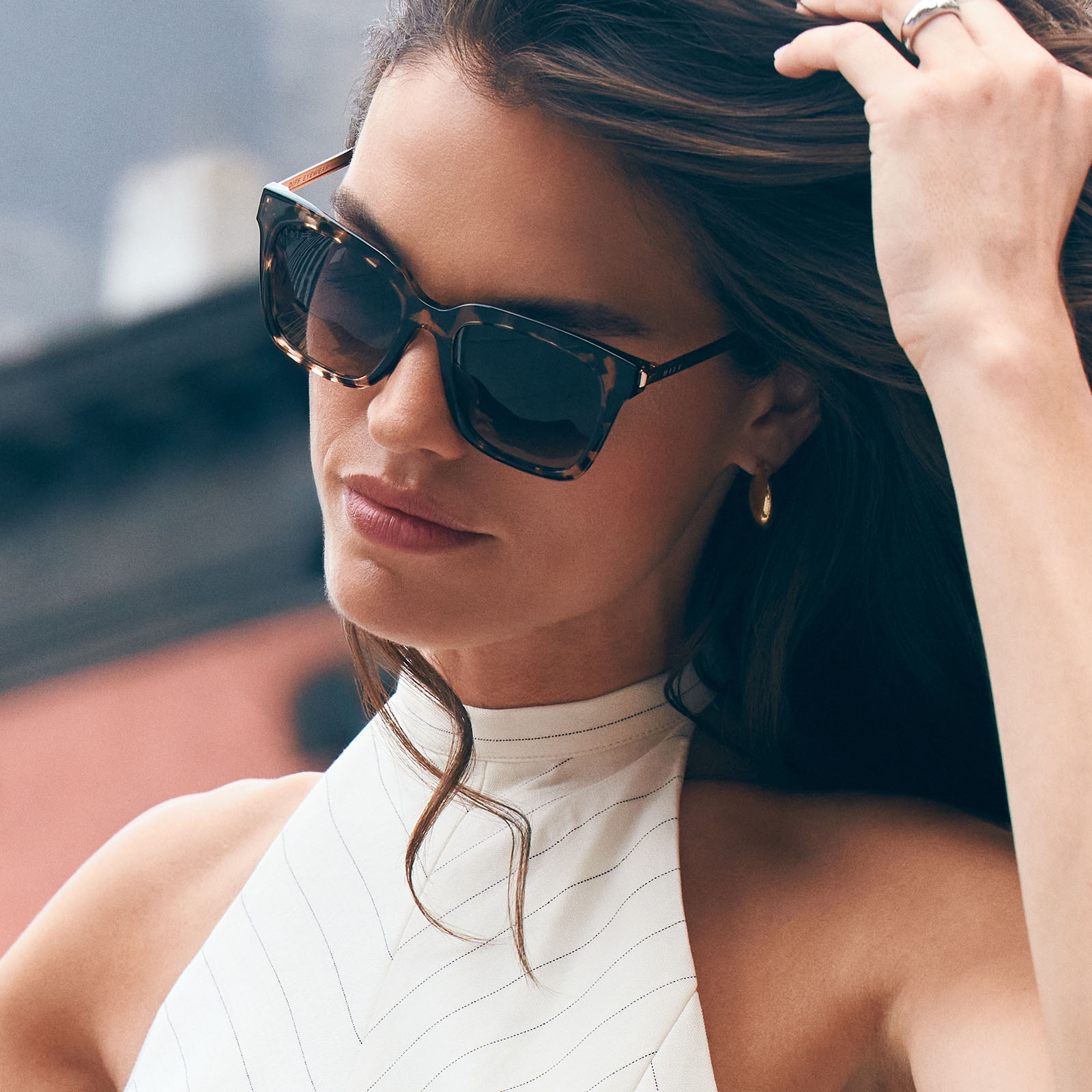 on model - female wearing wearing bella square sunglasses with a espresso tortoise frame and grey gradient lenses angled view
