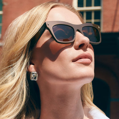 on model - female wearing on model - female wearing diff eyewear featuring the bradley cat eye sunglasses with a moscow mule frame and brown lenses angled view