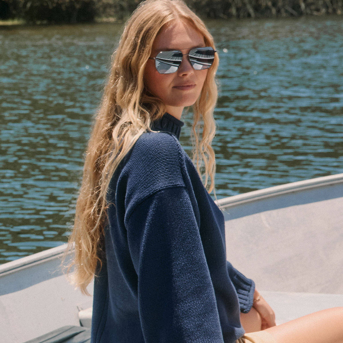 lifestyle - female on a boat wearing diff eyewear featuring the berkely navigator sunglasses with a gunmetal frame and slate gradient flash polarized lenses front view