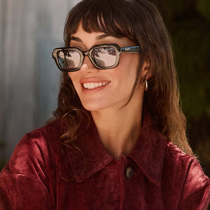 lifestyle - female wearing diff eyewear gwynn square sunglasses with a black acetate frame and light blue tint lenses front view