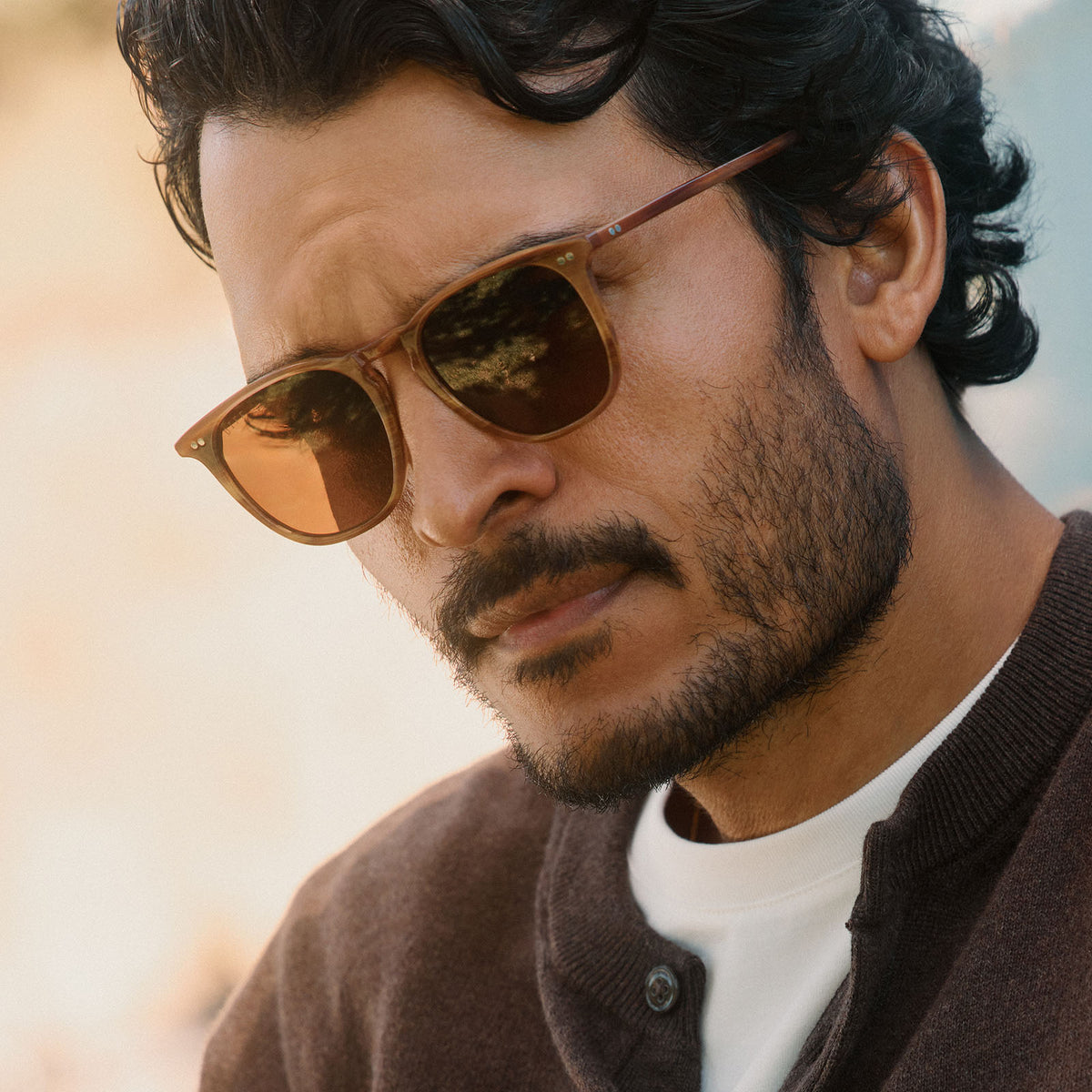 lifestyle - male wearing diff eyewear featuring the maxwell xl square sunglasses with a longhorn brown frame and brown polarized lenses angled view