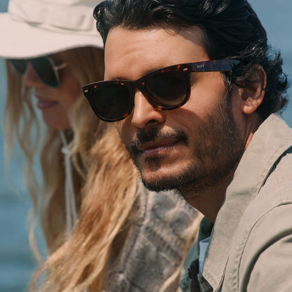 lifestyle - male wearing diff eyewear mercer square sunglasses with a rich tortoise acetate frame and g15 polarized lenses angled view