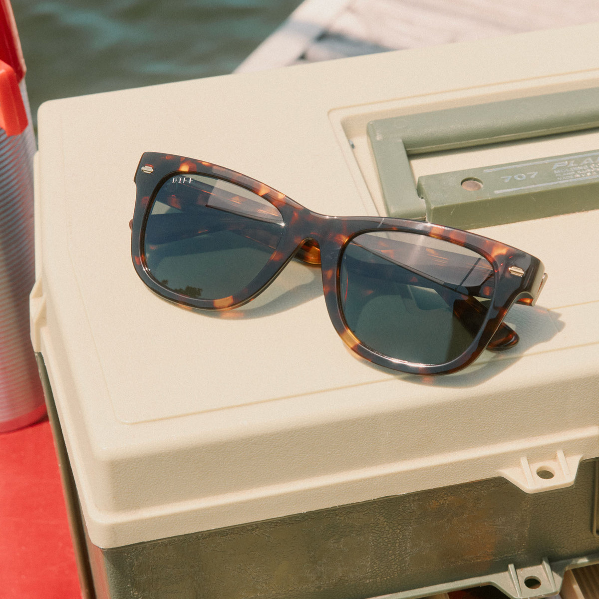 still life - diff eyewear mercer square sunglasses laying on a tackle box