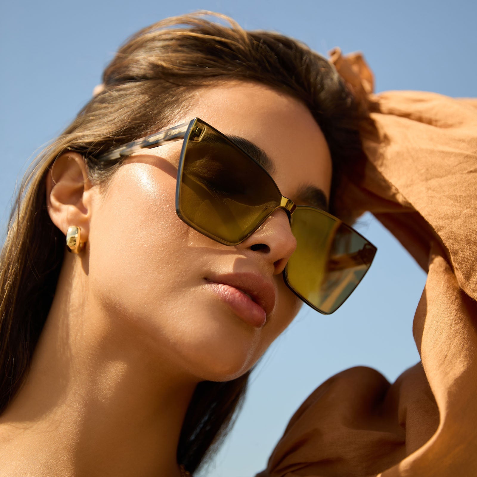 on model - female wearing diff eyewear featuring the goldie cateye sunglasses with a kombu frame and moss mirror lenses angled view