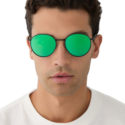 on model - male wearing harry potter x diff eyewear featuring the snape round sunglasses with a matte black metal frame and green mirror lenses front view