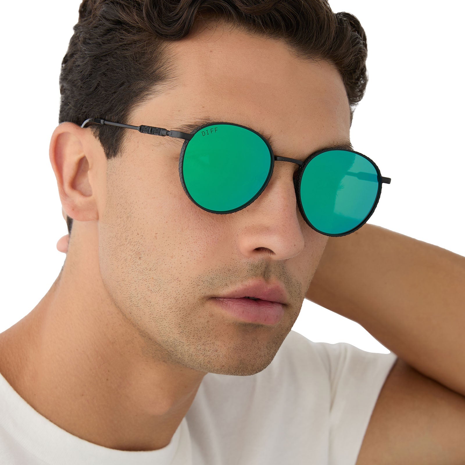 on model - male wearing harry potter x diff eyewear featuring the snape round sunglasses with a matte black metal frame and green mirror lenses angled view