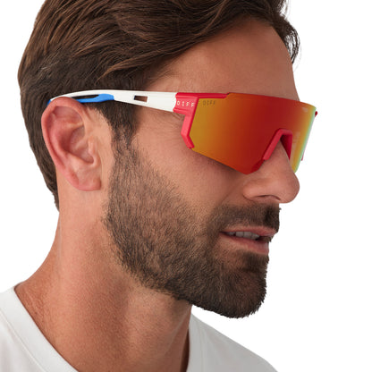 on model - male wearing diff sport featuring the heat shield sunglasses with a firecracker red frame and sunset mirror polarized lenses side view