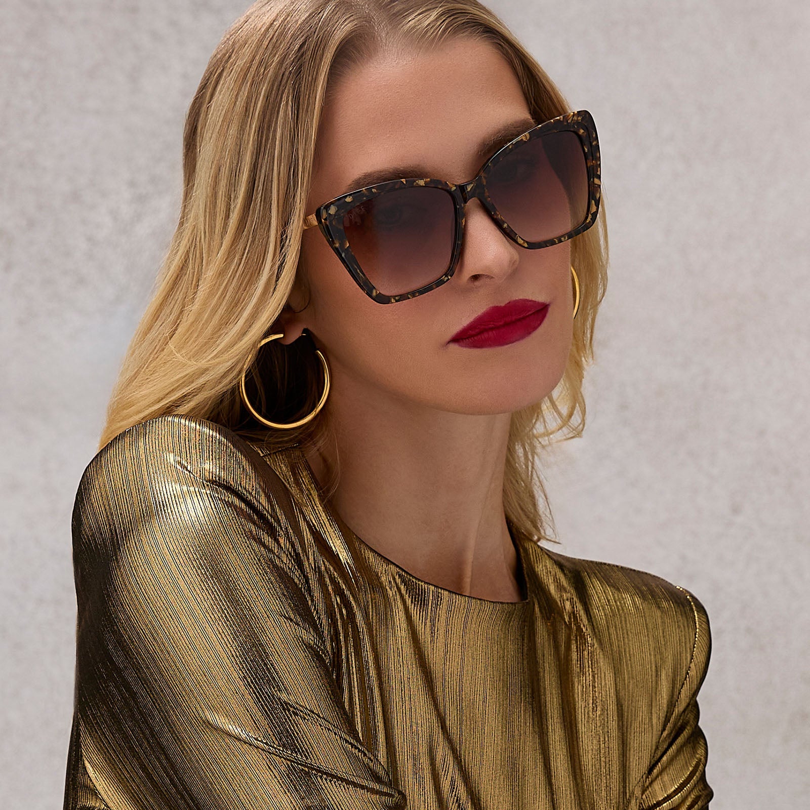 on model - female wearing diff eyewear featuring the becky ii cateye sunglasses with a glitter tortoise frame and brown gradient lenses angled view