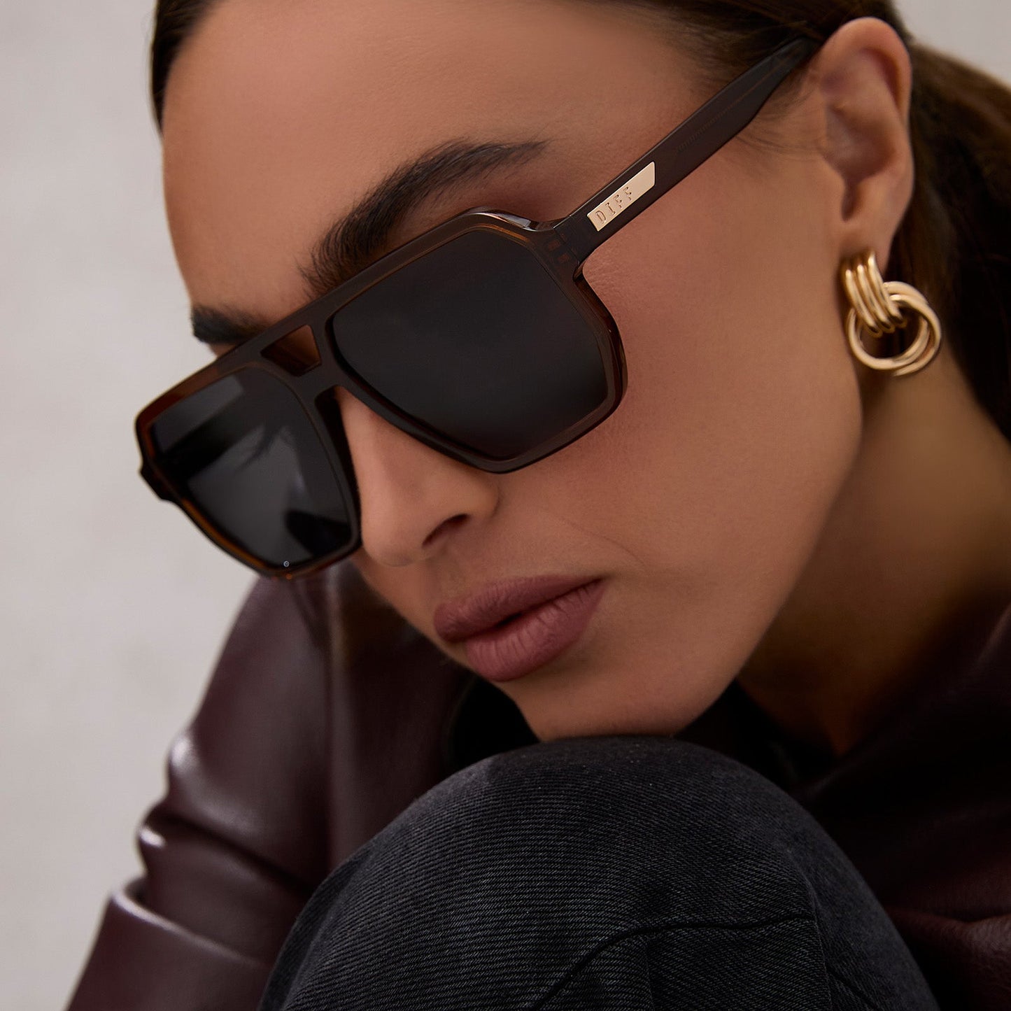 on model - female wearing diff eyewear featuring the cameron navigator sunglasses with a whiskey brown frame and grey polarized lenses angled view