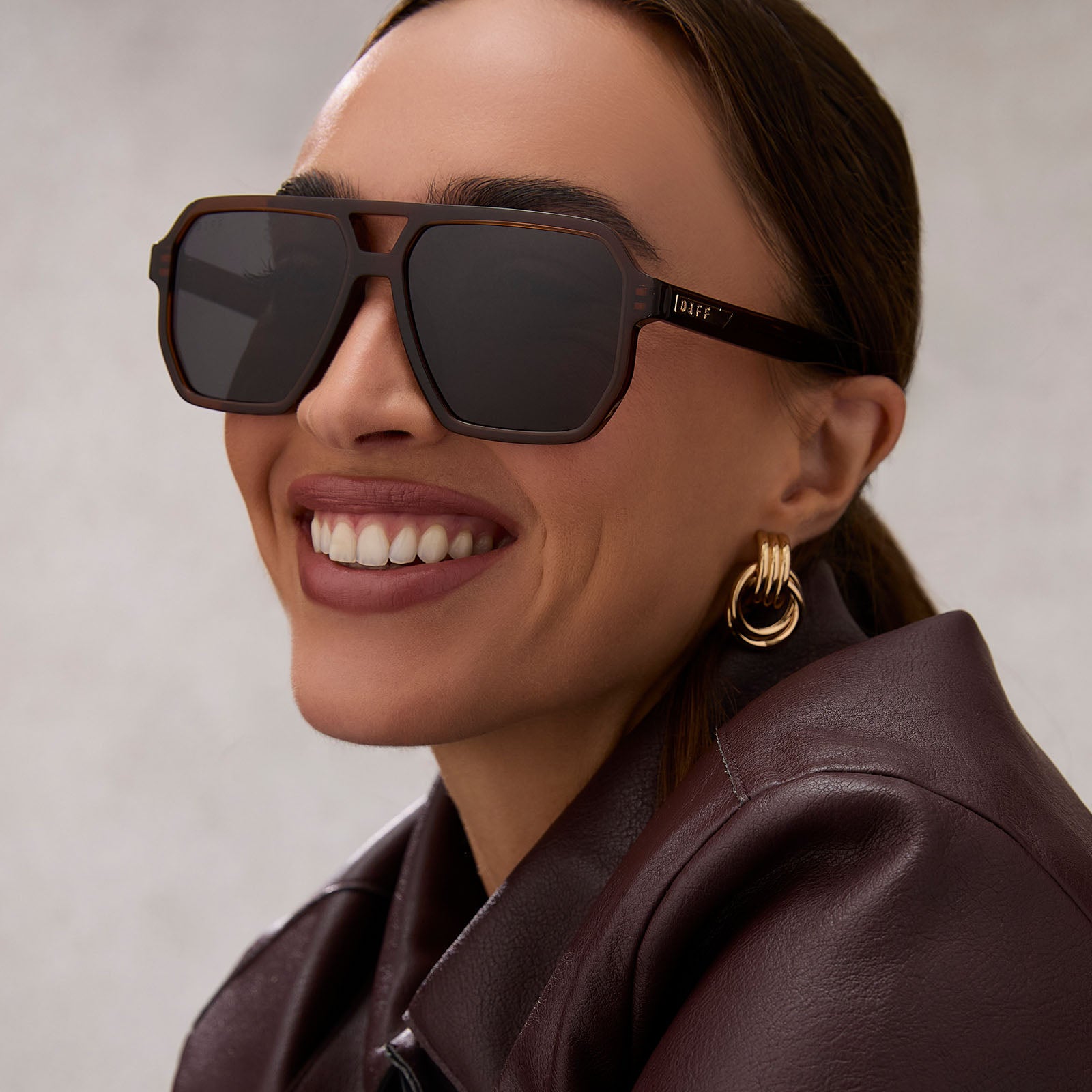 on model - female wearing diff eyewear featuring the cameron navigator sunglasses with a whiskey brown frame and grey polarized lenses front view