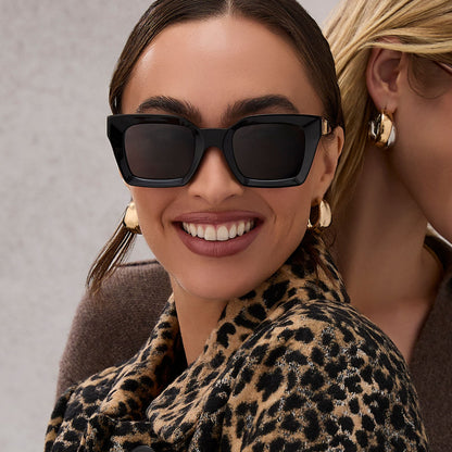 on model - female wearing diff eyewear featuring the greer square sunglasses with a black frame and grey lenses front view