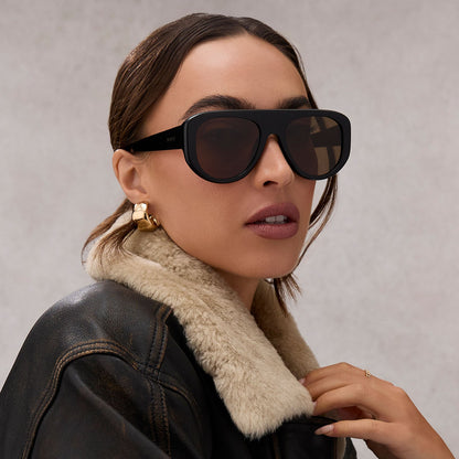 on model - female wearing diff eyewear featuring the morgan shield sunglasses with a black frame and brown lenses front view