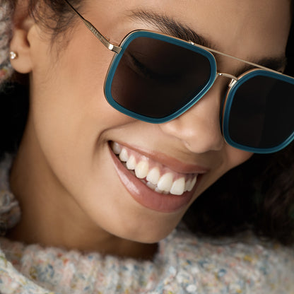 on model - female wearing diff eyewear featuring the jordan navigator sunglasses with a dark teal frame and grey polarized lenses angled view