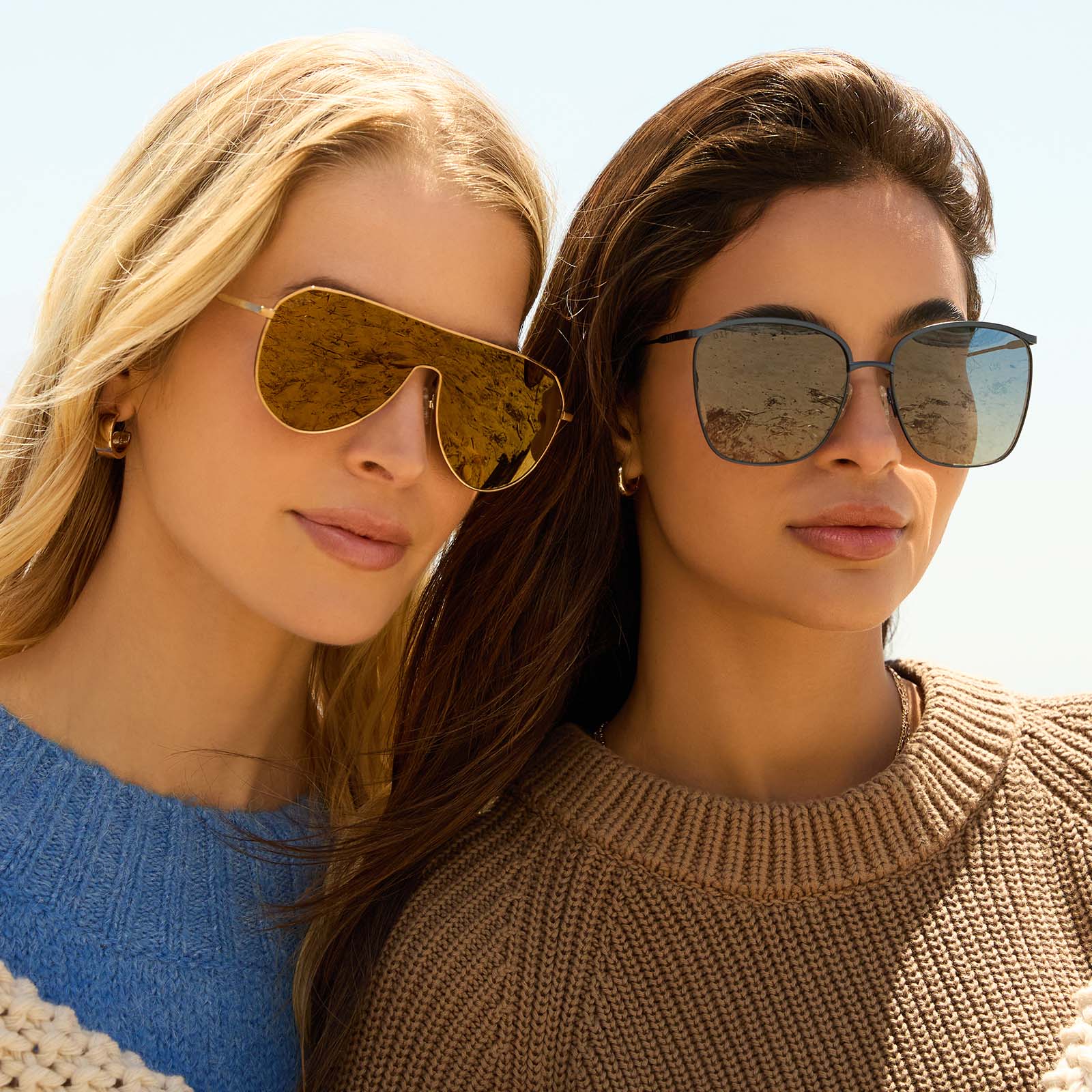 on model - two females wearing the dash shield copper brown sunglasses and the other wearing vittoria deep navy sunglasses