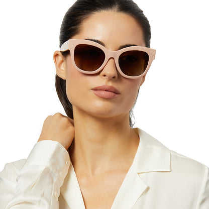 on model - female wearing iconica x diff eyewear eva cat eye sunglasses with a nude peach frame and brown gradient polarized lenses front view