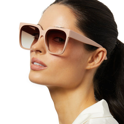 on model - female wearing icoinca x diff eyewear thea oversized square sunglasses with a nude acetate frame and brown gradient lenses angled view