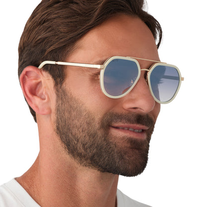 on model - male wearing diff eyewear featuring the joey round sunglasses with a courtside ivory & gold metal frame with blue slate gradient flash lenses angled view