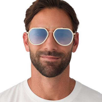 on model - male wearing diff eyewear featuring the joey round sunglasses with a courtside ivory & gold metal frame with blue slate gradient flash lenses front view