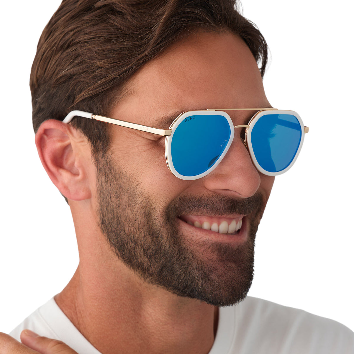 on model - male wearing diff eyewear featuring the joey round sunglasses with a snowbound & gold metal frame with blue mirror lenses angled view