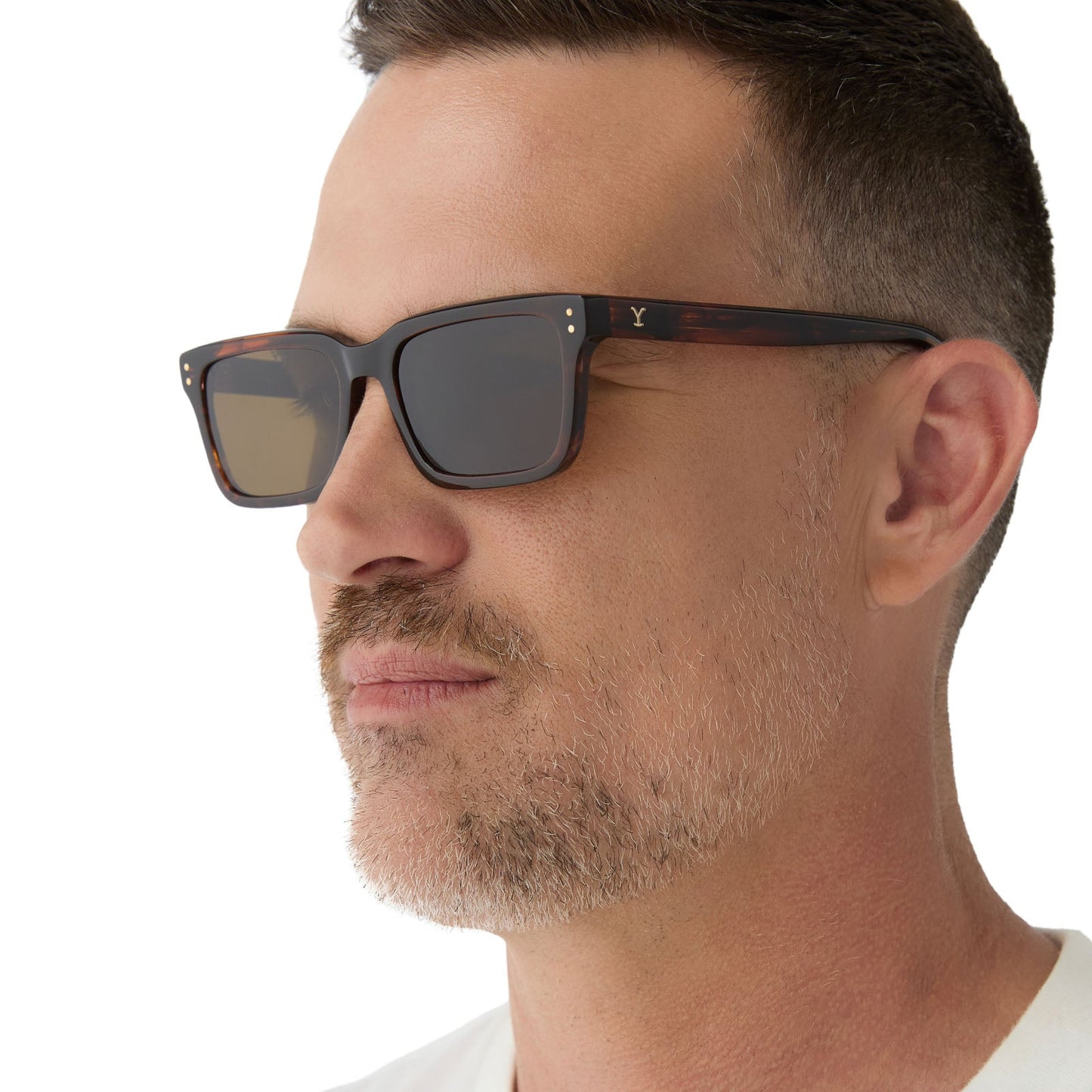 on model - male wearing yellowstone x diff eyewear featuring the john dutton rectangle sunglasses with a sequoia tortoise frame and brown polarized lenses side view