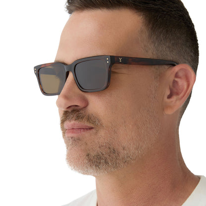on model - male wearing yellowstone x diff eyewear featuring the john dutton rectangle sunglasses with a sequoia tortoise frame and brown polarized lenses side view