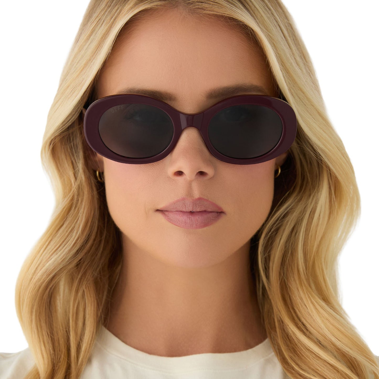 on model - female wearing diff eyewear featuring the lainey oval sunglasses with a dark cherry lacquer frame and grey lenses front view