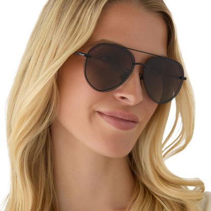 on model - female wearing diff eyewear featuring the lenox aviator sunglasses with a black + black temple tips frame and brown gradient polarized lenses angled view