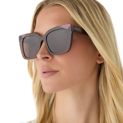 on model - female wearing diff eyewear featuring the lizzy cat eye sunglasses with a whiskey + torino tortoise frame and brown lenses angled view