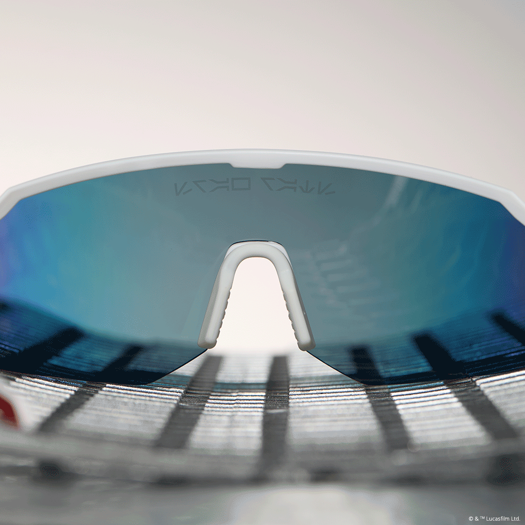 lifestyle - star wars™ x diff sport featuring the luke x-wing™ 2.0 shield sunglasses with a white frame and red orange fire mirror polarized lenses nose guard bridge animation
