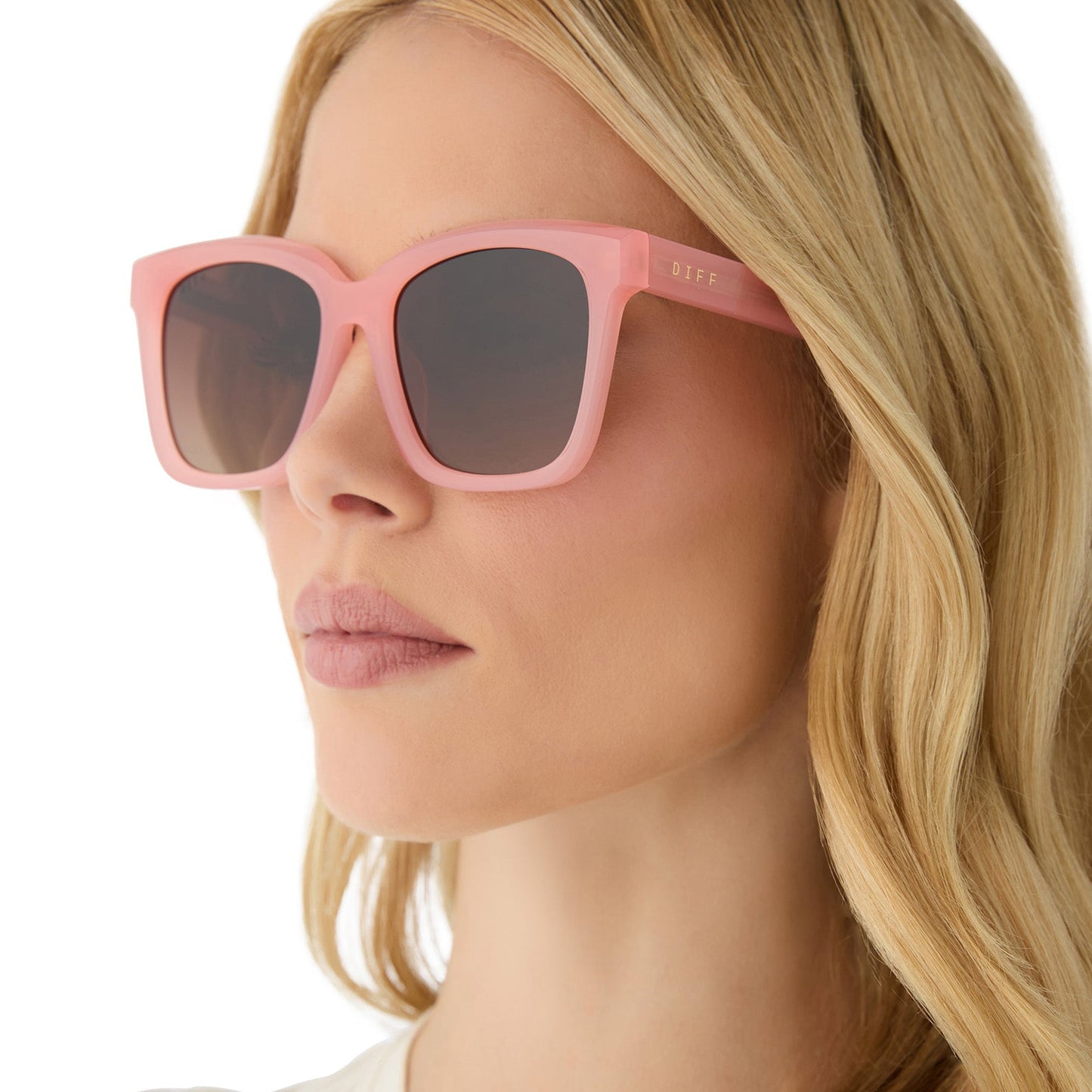 on model - female wearing diff eyewear featuring the meredith square sunglasses with a peach frame and brown gradient polarized lenses angled view