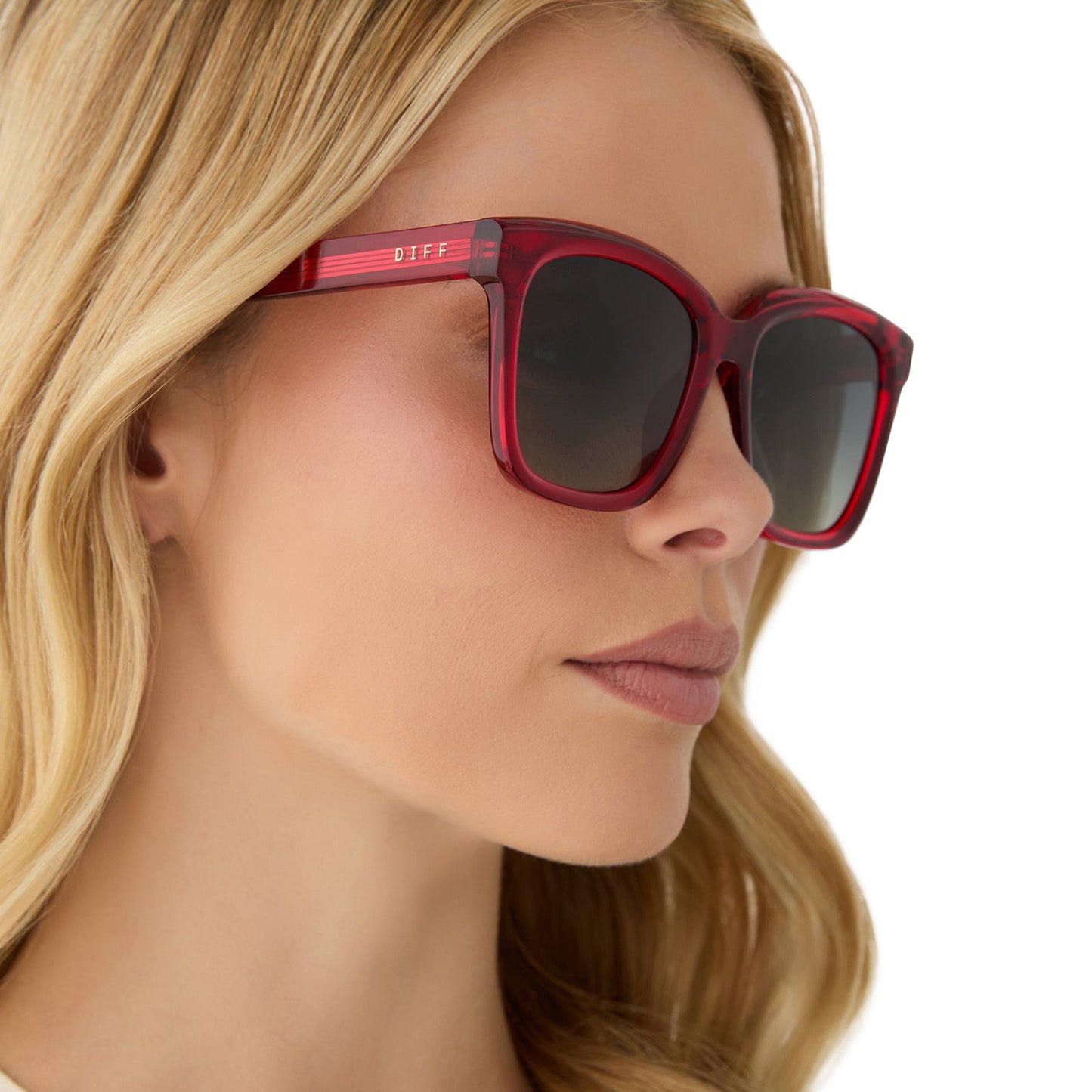 on model - female wearing diff eyewear featuring the meredith square sunglasses with a red hot summer frame and grey gradient polarized lenses side view