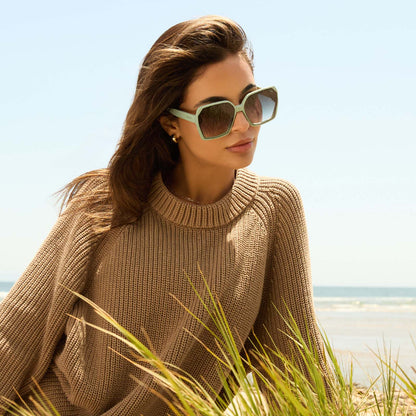 on model - female wearing diff eyewear featuring the presley square sunglasses with a steel teal frame and grey gradient lenses angled view