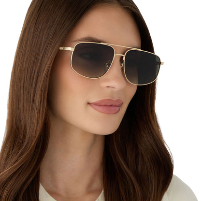 on model - female wearing diff eyewear featuring the charley navigator sunglasses with a brushed gold metal frame and aloe green gradient lenses angled view