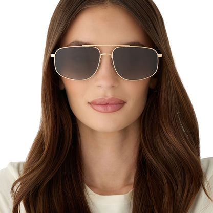 on model - female wearing diff eyewear featuring the charley navigator sunglasses with a brushed gold metal frame and aloe green gradient lenses front view