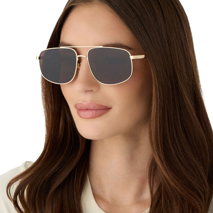on model - female wearing diff eyewear featuring the charley navigator sunglasses with a gold metal frame and brown polarized lenses angled view